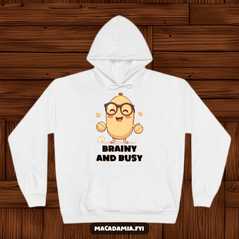 Funny hoodie showcasing a smiling macadamia nut in glasses, expertly juggling three smaller nuts, a symbol of cleverness and fun.