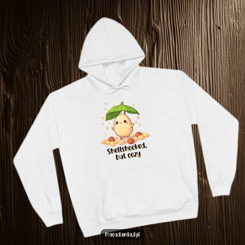 Funny macadamia nut character with leaf umbrella, caught in a candy nut drizzle, cozy hoodie design for a funny gift.
