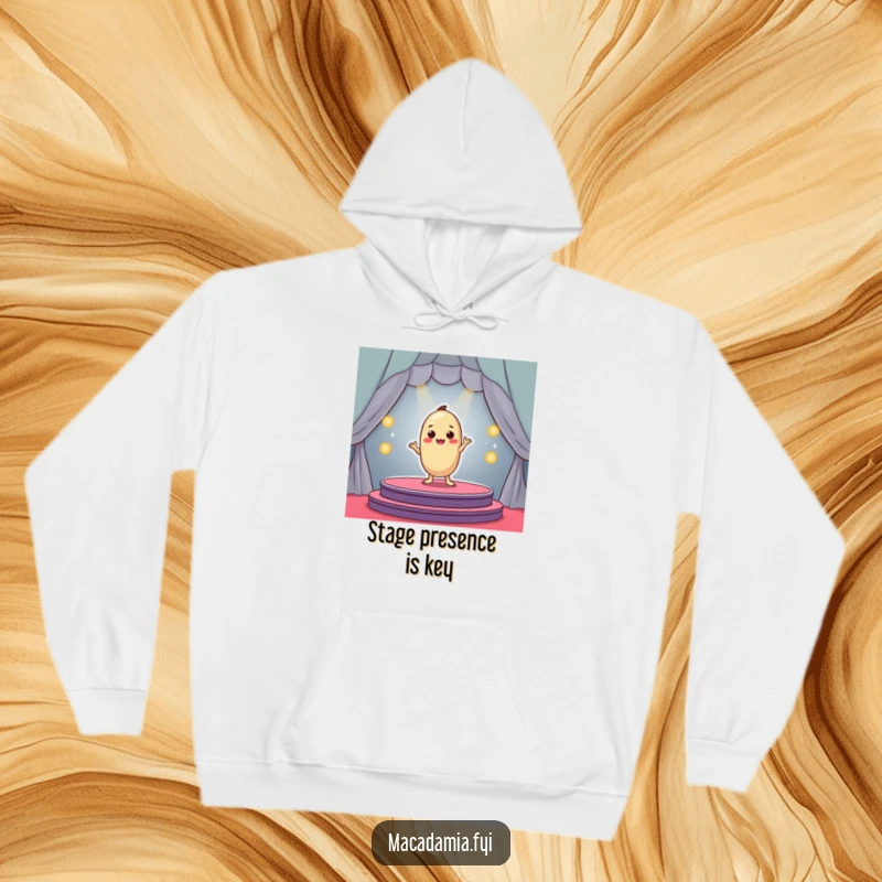 Funny macadamia nut character performing dramatically on a mini stage, cozy hoodie design, great funny gift.