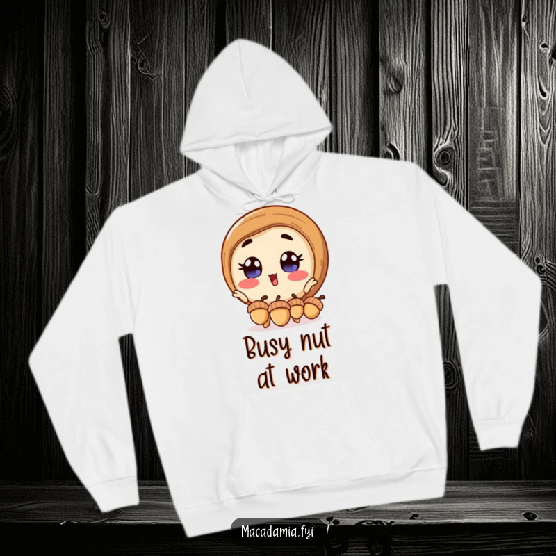 Funny macadamia nut hoodie featuring an excited macadamia nut with wide eyes, juggling acorns, offering warmth and humorous delight.