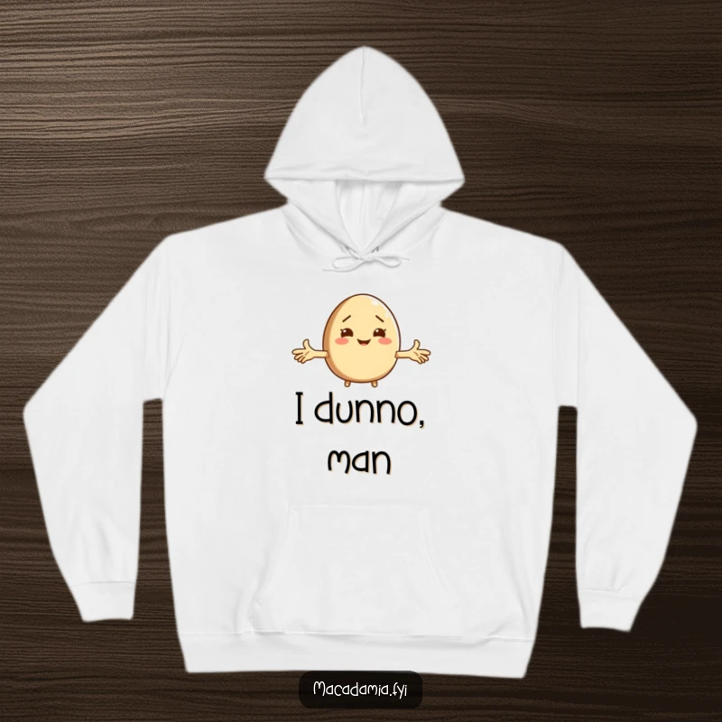 Funny macadamia nut character shrugging with arms wide, featured on a soft hoodie, perfect for cozy, humorous moments.