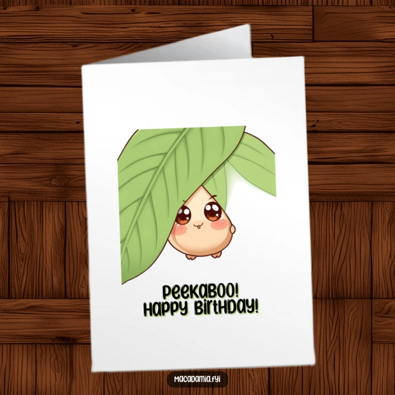 Funny Free Printable Birthday Card: A wide-eyed macadamia nut peeking from behind a large green leaf.