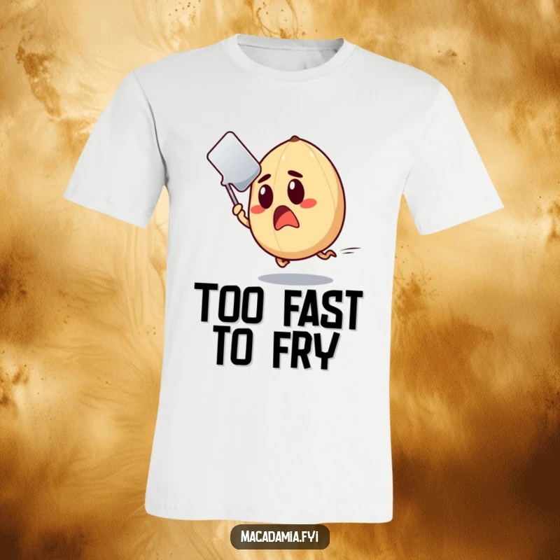 Funny Macadamia Nut T-Shirt featuring a wide-eyed nut fleeing a swiftly approaching spatula.