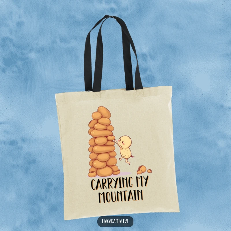 Funny tote bag with a macadamia nut character attempting to climb a giant, wobbly stack of macadamia nuts, ideal for carrying essentials.